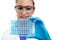 Scientist woman examining a microplate