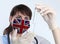 Scientist woman and mask with Great Britain flag. Research of viruses in laboratory for prevention of a pandemic in Great Britain