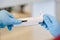 Scientist working in chemical laboratory with automatic pipette.