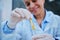 Scientist working colored litmus paper in hand in a research lab. chemist in examines a sample of water contamination