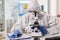 Scientist working to discover virus vaccine dressed in ppe suit