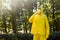 Scientist in yellow protective suit, glasses and respirator. Portrait of man on the background of blurred trees