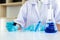 Scientists are carrying blue chemical test tubes to prepare for the determination of chemical composition and biological mass in a