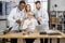 Scientists posing on camera in front of laptop at work