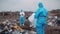 Scientists with rotective suit, investigated and inspected garbage pile in landfill