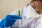 Scientists wearing masks and gloves Holding a syringe with a vaccine to prevent covid-19