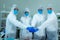 Scientists wearing protective suit and face mask  diagnosis vaccine virus in science clinical