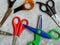 Scissors for children and adults for different purposes on a gray background. Scissors for seamstress, hair cutting