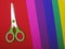 Scissors on color paper background