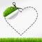 Scissors cut heart sticker. Green grass