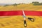 Scissors cut the red ribbon overlooking the fields and vineyards of sunny Tuscany, Italy