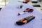 scissors, cutter and screwdriver on a table. Tools of an electrician worker placed in a row on a violet carpet