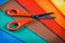 Scissors lying on colorful cardboard