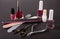 Scissors, nail files and clippers manicure with polish bottles on a dark background