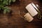 scissors, twisted cotton rope and burlap cord on wooden table decorated with spruce branches