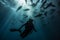 a scooba diver diving underwater with sharks in the ocean