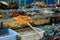 Scoop net resting on tanks with fresh seafood at a street market in China