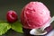 Scoop of raspberry ice cream with fresh fruit and green leaf