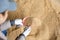 Scoop with soy husk in hands of female farmer