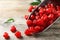 Scoop of sweet cherries on wooden background, closeup.