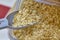 Scooping Bulk Oats in Health Food Store, Close-Up Perspective