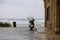 Scooter on the beach next to a stone castle