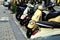 scooters and motor bikes parked in a row in busy downtown street. patio and street restaurant terrace