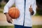 Score more with self belief. an unrecognisable man showing thumbs up while playing basketball at college.