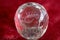 Scorpio and stars inside a transparent faceted abstract crystal on a bright red background