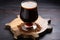 scotch ale in a goblet-style glass on a stone coaster