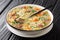 Scotch broth is a Scottish soup traditionally featuring barley, a meat lamb, root vegetables  closeup in the plate. Horizontal