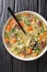 Scotch broth is a traditional Scottish soup made from lamb, and vegetables, barley, peas closeup in the plate. Vertical top view