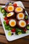 Scotch eggs served with greens and leek, Scottish traditional dish at plate