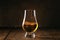 Scotch Whiskey without ice in glass, rustic wood background, copy space