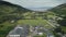 Scotland aerial view: whiskey distillery Loch Ranza, greenery village, mountain valley, camp town