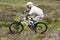 Scotland - August 14, 2010: Cyclists descending down a steep slope among the muddy mountains