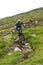 Scotland - August 14, 2010: Cyclists descending down a steep slope among the muddy mountains