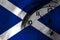 Scotland, Scottish, Scots flag with clock close to midnight in the background. Happy New Year concept