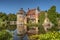 Scotney Castle and moat reflection wide view