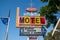 Scott Shady Court Motel retro vintage neon sign against a blue sky