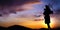 Scottish bagpiper at sunset