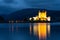 Scottish castle reflecting in still water at night
