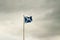 Scottish flag against overcast skies