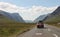 Scottish Highlands landscape in summer - old car on the road in the valley.
