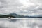 A scottish lake with a solitary sailboat