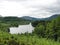 Scottish Loch in summer surrounded by green woods