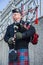 Scottish piper playing music with bagpipe, Edinburgh, Scotland