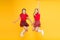 Scottish style. Cheerful friends schoolgirls jumping yellow background. Celebrate holiday. Scottish holiday. Join