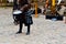 A Scottish warrior, soldier, musician in traditional costume with a skirt beats the drum on the square of a medieval old castle.