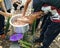 Scout boys preparing Chicken inside bamboo are grilled with flame for camping cooking method and also traditional cooking method.